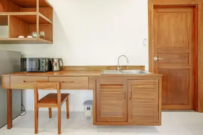 a kitchen with a sink and a wooden desk at A102 Banjong 1 Bed apart Near Nai Harn Beach in Rawai Beach