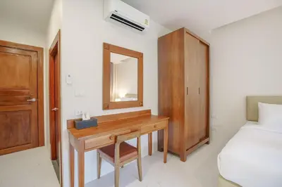 a bedroom with a desk and a bed and a mirror at A102 Banjong 1 Bed apart Near Nai Harn Beach in Rawai Beach