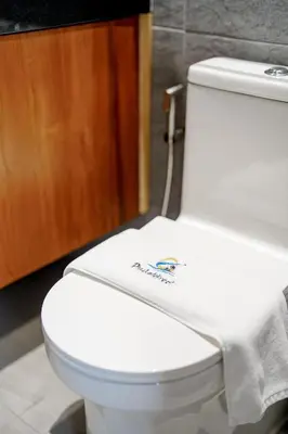 a bathroom with a white toilet with a towel on it at A102 Banjong 1 Bed apart Near Nai Harn Beach in Rawai Beach