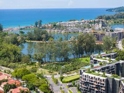 an aerial view of a city with a river and buildings at Двухкомнатные апартаменты Laguna Skypark in Laguna Phuket