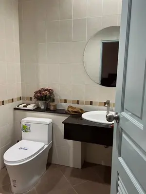 a bathroom with a toilet and a sink at Roomy renovated Apartments in Phuket in Ban Sam Kong