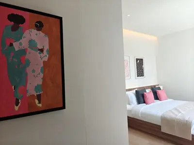 a bedroom with a bed and a painting on the wall at Aileen Layan Villa 2 Private Pool 4Bedroom in Phuket Town