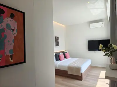 a bedroom with a bed with pink pillows at Aileen Layan Villa 2 Private Pool 4Bedroom in Phuket Town