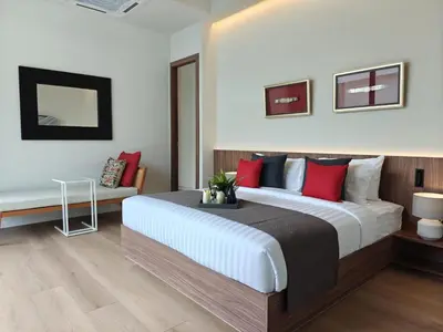 a bedroom with a large bed with red pillows at Aileen Layan Villa 2 Private Pool 4Bedroom in Phuket Town