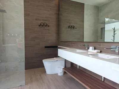 a bathroom with a toilet and a sink and a mirror at Aileen Layan Villa 2 Private Pool 4Bedroom in Phuket Town