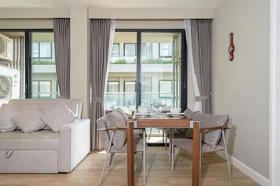 a living room with a table and a couch at 2BR Apt 2510 Gem Resort near Bangtao Beach in Bang Tao Beach