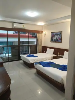 a hotel room with two beds and a balcony at Patong \u4e00\u5367\u4e09\u4eba\u95f4 in Patong Beach