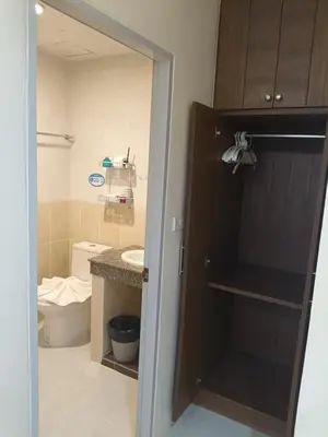a bathroom with a sink and a toilet and a door at Patong \u4e00\u5367\u4e09\u4eba\u95f4 in Patong Beach