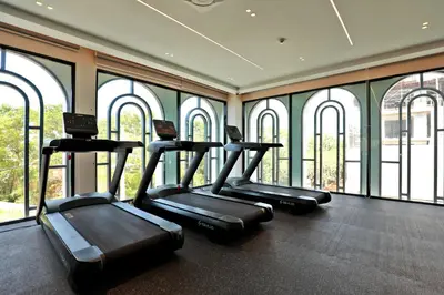 a row of treadmills in a gym with windows at 1BR Apartment near Bang-Tao Beach CapitalPro TLB-H206 in Bang Tao Beach