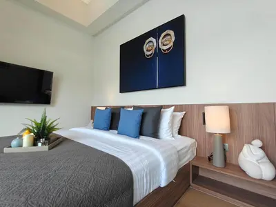 a bedroom with a large bed with blue pillows at Aileen Layan Villa 3 Private Pool 4 Bedroom in Phuket Town