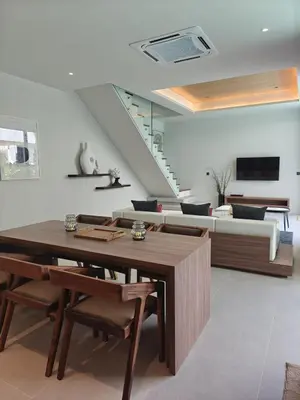 a living room with a table and a couch at Aileen Layan Villa 3 Private Pool 4 Bedroom in Phuket Town