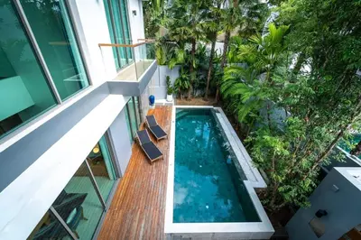 an external view of a house with a swimming pool at Luxury Teak 4BR Private Pool Villa in Bang Tao in Laguna Phuket