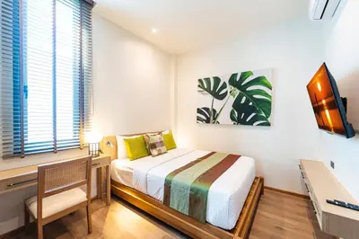 a bedroom with a bed and a desk and a tv at Luxury Teak 4BR Private Pool Villa in Bang Tao in Laguna Phuket