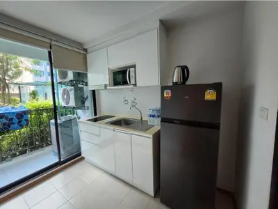 a small kitchen with a refrigerator and a sink at cen807 in Phuket Town
