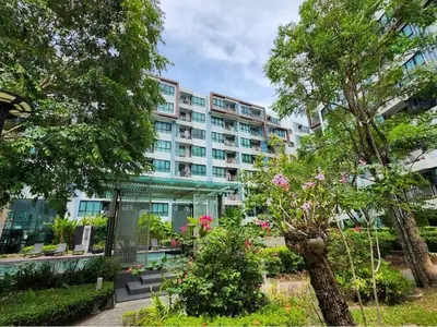 a large apartment building with a garden in front of it at cen807 in Phuket Town