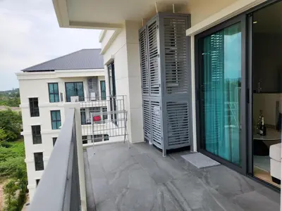 a balcony with a view of a building at WEG Title Legendary in Bang Tao Beach
