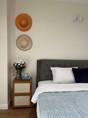 a bedroom with a bed and a vase of flowers at Roomy renovated Apartments in Phuket in Ban Sam Kong
