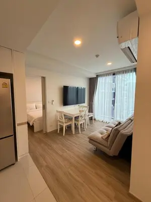 a hotel room with a bed and a dining room at Laguna SkyPark in Laguna Phuket
