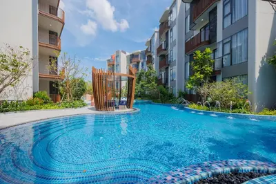 a swimming pool in front of some apartment buildings at Suite Eden 1BRGarden PoolCanvas Bang Tao Beach in Laguna Phuket