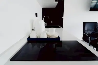 a kitchen with a table with plates and a sink at 3Bedrooms Mountain View at Patong Tower Phuket in Patong Beach