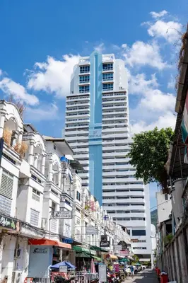 a tall blue building in the middle of a city at 3Bedrooms Mountain View at Patong Tower Phuket in Patong Beach