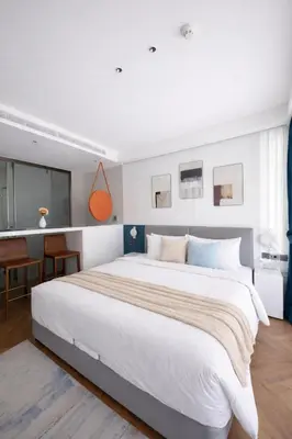 a bedroom with a large white bed in a room at Beach Resort along coastline of Layan beach in Layan Beach