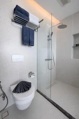 a bathroom with a toilet and a glass shower at Beach Resort along coastline of Layan beach in Layan Beach