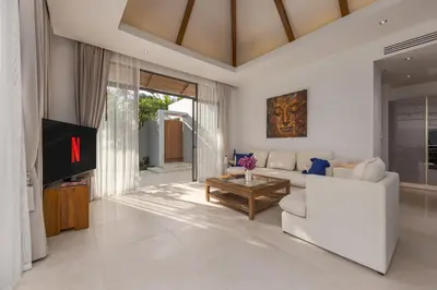 a living room with a white couch and a table at Modern 3BR Villa Kaimana with Private Pool in Ban Phru Champa