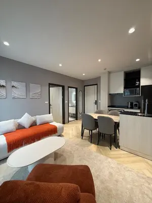 a living room with a couch and a table at Title Legendary 2 bedroom in Bang Tao Beach