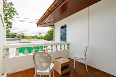 a room with a balcony with a chair and a table at Villa Mayfair 4 bedrooms sea view with pool table in Ban Bang Chak