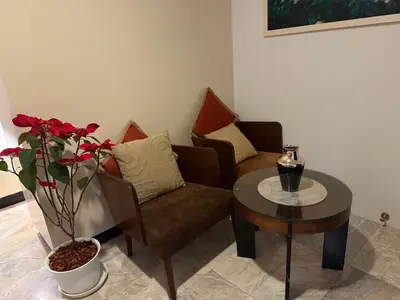 a living room with a couch and a table at Phuket Rawai beachfront by Tris in Nai Harn Beach