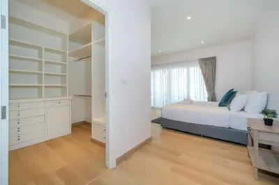 a bedroom with a bed and a large mirror at Espuma Patong pool villa in Patong Beach