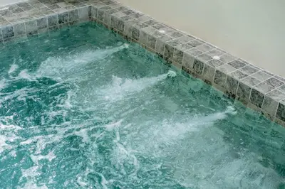 a large pool of water with a tile ledge at Suite dream villa Bangla Patong sleep 8 in Patong Beach