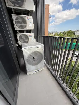 two boxes are sitting on the balcony of a building at Sky Park Family Comfort in Laguna Phuket