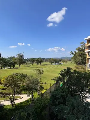 a view of the golf course from the balcony of a resort at SkyPark Laguna, 1 Bedroom Apartment in Phuket