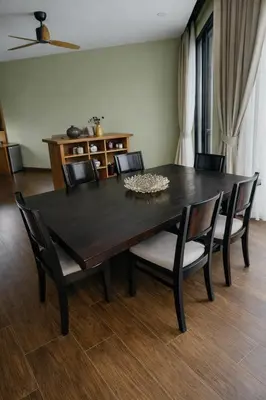 a dining room table with chairs and a black table at Private Pool Villa Baan Bua in Phuket Town