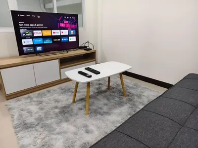a white coffee table with two remote controls on it at The Blue Oasis Cozy Phuket Getaway in Ban Ket Ho