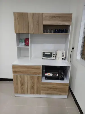 a kitchen with wooden cabinets and a microwave at The Blue Oasis Cozy Phuket Getaway in Ban Ket Ho