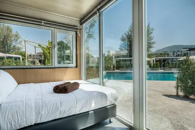 a bedroom with a bed with a towel on it at Apple House seaside home and pool in Ban Lum Fuang