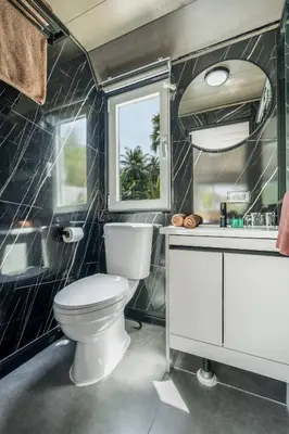a bathroom with a toilet and a sink at Apple House Phuket a cozy home terrace &pool&beach in Ban Lum Fuang