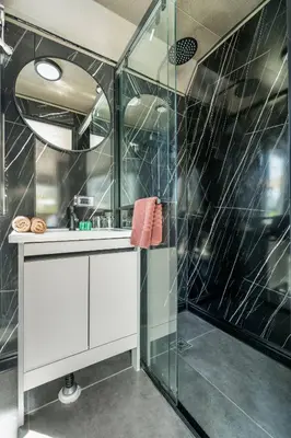 a bathroom with a glass shower and a sink at Apple House Phuket a cozy home terrace &pool&beach in Ban Lum Fuang