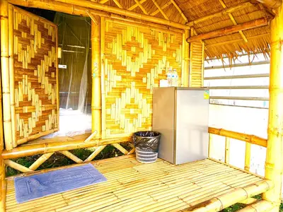 a refrigerator in the inside of a wooden cabin at Patong Canal House 3 in Patong Beach