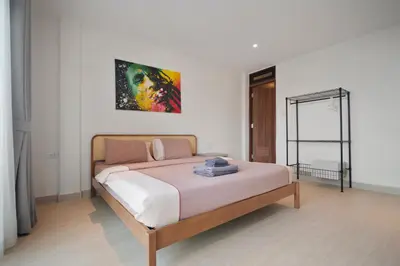 a bedroom with a large bed in a room at Patong Boutique in Patong Beach