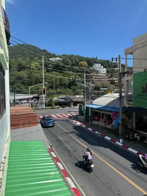 a person riding a motorcycle on a city street at KataKeet in Kata Beach