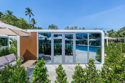 a house with a pool and glass walls at Apple House Bangtao 1 Min Beach Pool & Breakfast in Ban Lum Fuang