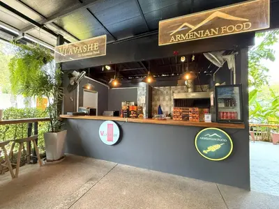 a food stand with a counter and signage at Apple House Phuket Near Beach with Pool & Terrace in Ban Lum Fuang