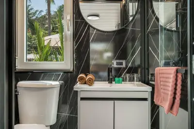 a bathroom with a toilet and a sink and a mirror at Bangtao Apple House Peace by the Sea in Ban Lum Fuang