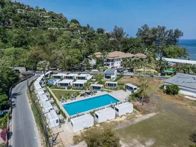 an aerial view of a resort with a swimming pool at Cozy Apple House Bangtao Poolside Beach Retreat in Ban Lum Fuang