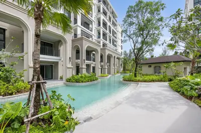 a swimming pool in front of a building at Evora 1BR Suite — The Title Legendary BangTao in Bang Tao Beach
