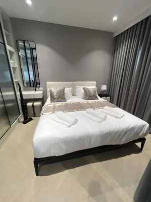 a bedroom with a large white bed and a desk at The Title Legendary Bang-Tao access to the pool in Bang Tao Beach